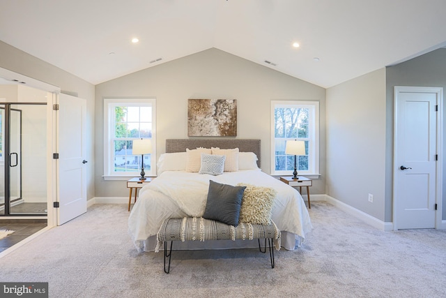 bedroom with vaulted ceiling, light carpet, and multiple windows