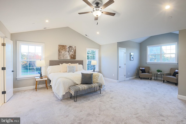 bedroom featuring light colored carpet, vaulted ceiling, and ceiling fan