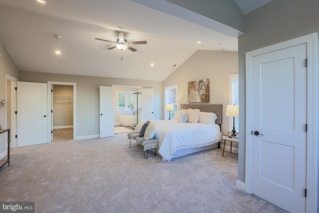 bedroom with light colored carpet, ceiling fan, lofted ceiling, and a walk in closet