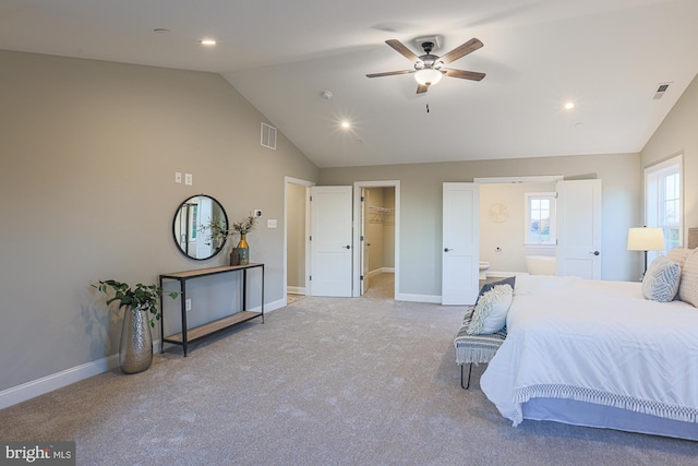 carpeted bedroom featuring a closet, ceiling fan, lofted ceiling, and a walk in closet