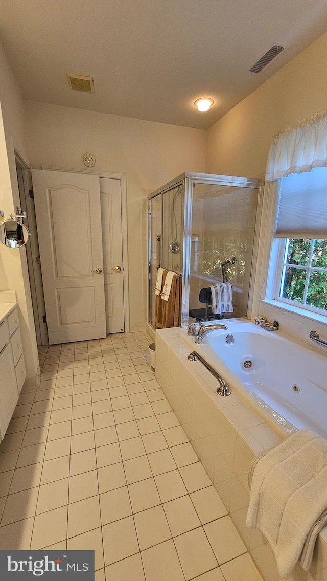 bathroom featuring vanity, shower with separate bathtub, and tile patterned flooring