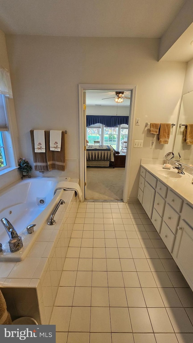 bathroom featuring vanity, tiled bath, tile patterned floors, and ceiling fan