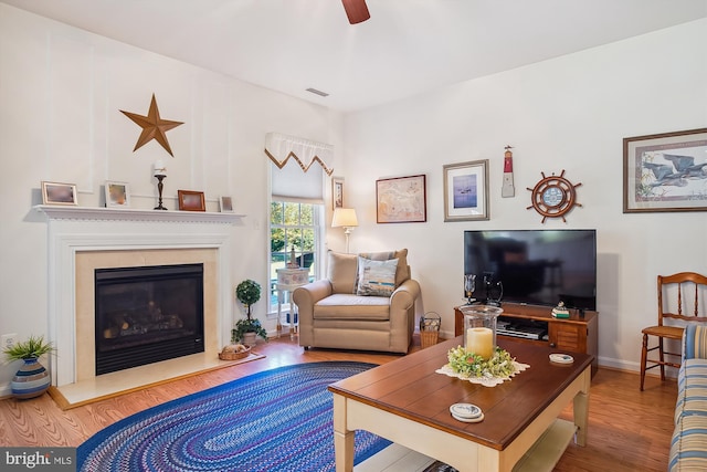 29748 Lyons Dr, Easton, MD 21601 - living area with visible vents, a high end fireplace, ceiling fan, and wood finished floors