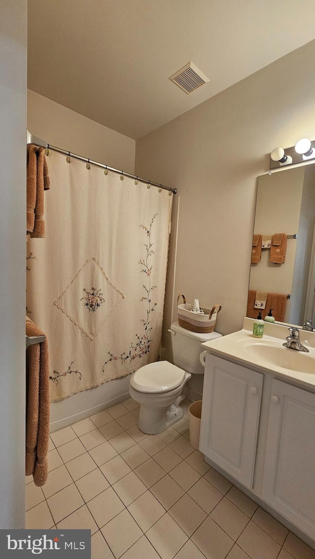 full bathroom featuring toilet, shower / bath combo with shower curtain, vanity, and tile patterned flooring