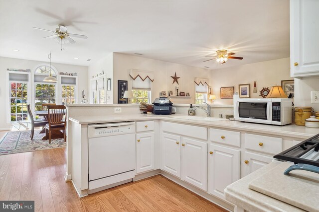 29748 Lyons Dr, Easton, MD 21601 - kitchen with a sink, white appliances, white cabinetry, and a ceiling fan