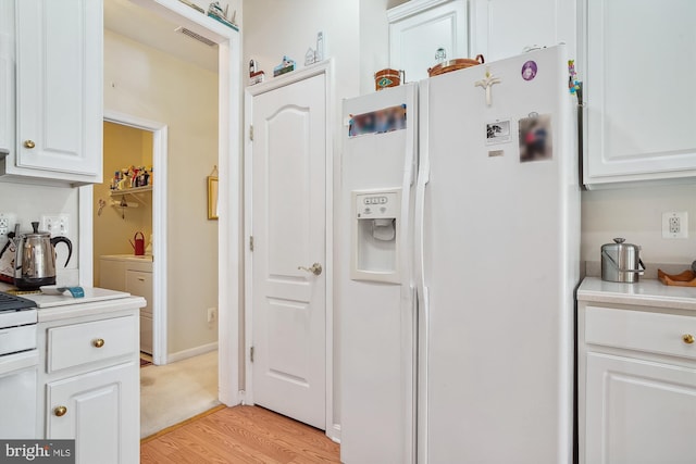 29748 Lyons Dr, Easton, MD 21601 - kitchen featuring light countertops, white cabinets, and white refrigerator with ice dispenser
