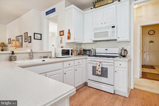 29748 Lyons Dr, Easton, MD 21601 - kitchen with a sink, light wood-style flooring, white appliances, and white cabinets
