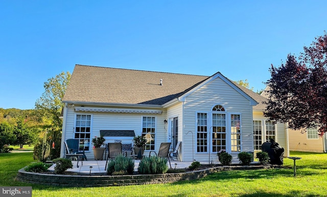 back of property featuring a patio and a lawn