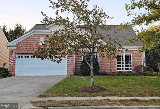 view of front of house with a front yard and a garage