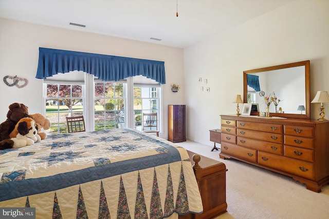 bedroom with access to outside and light colored carpet