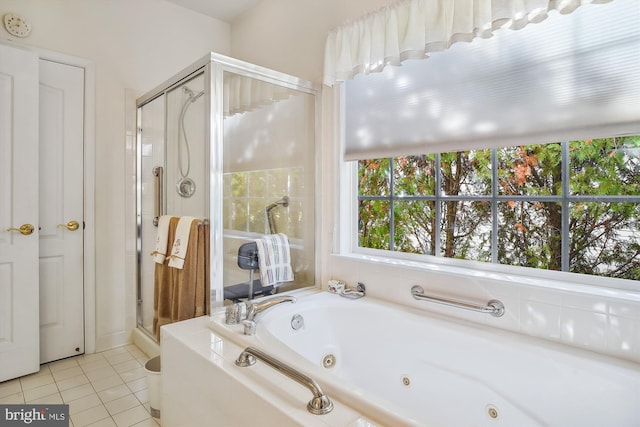 bathroom with tile patterned floors and shower with separate bathtub