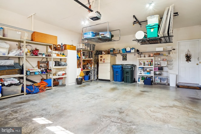 garage featuring a garage door opener and white refrigerator