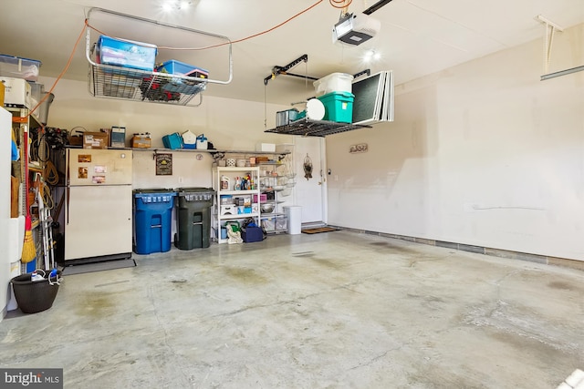 garage featuring a garage door opener and white refrigerator