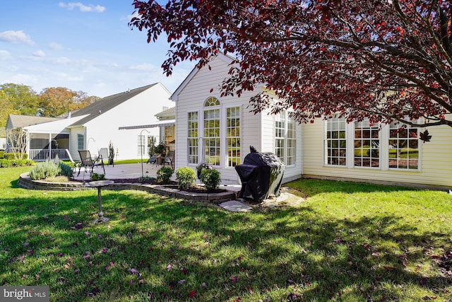 rear view of property with a patio area and a lawn