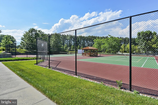 view of sport court featuring a yard