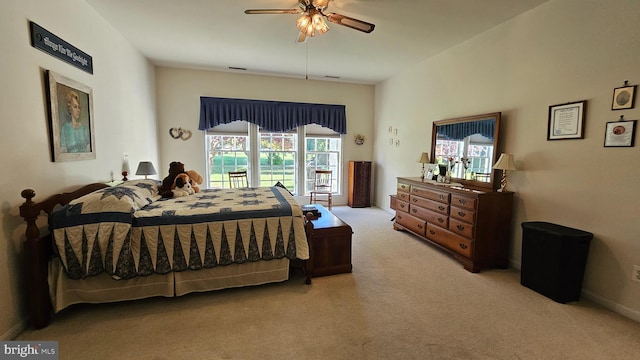 bedroom with multiple windows, light colored carpet, and ceiling fan