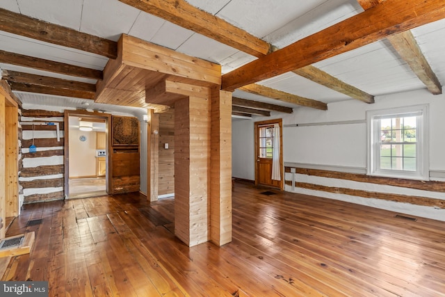 interior space with beamed ceiling and hardwood / wood-style floors