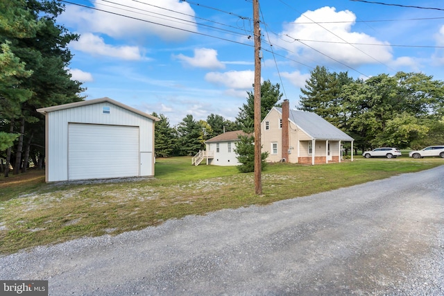 exterior space with a yard, an outbuilding, and a garage