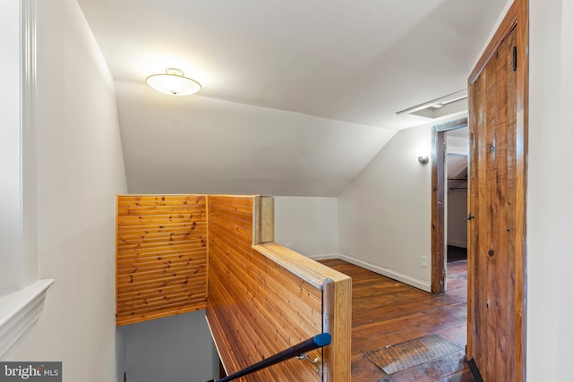 stairway with lofted ceiling and hardwood / wood-style flooring