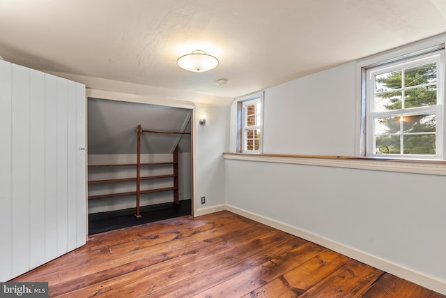 unfurnished bedroom featuring a closet and dark wood-type flooring