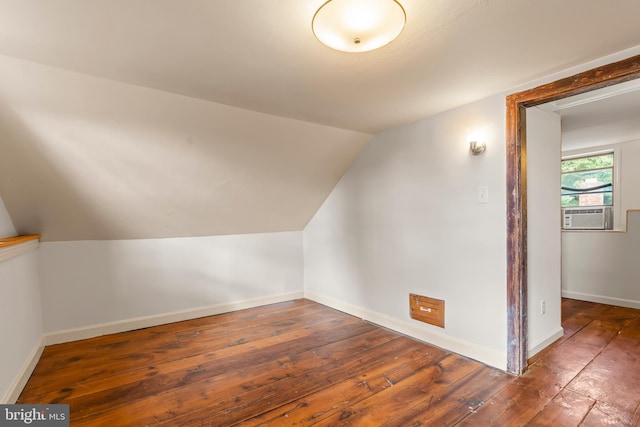 additional living space with lofted ceiling, dark hardwood / wood-style floors, and cooling unit