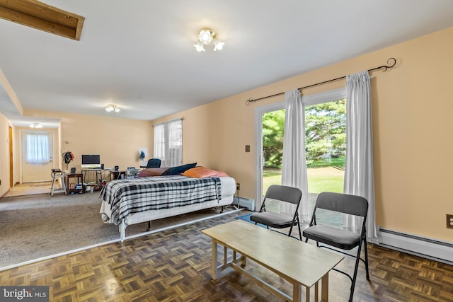 bedroom with a baseboard heating unit and dark parquet flooring