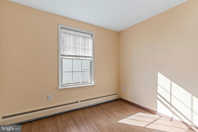 unfurnished room featuring light hardwood / wood-style floors and baseboard heating