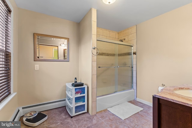 bathroom with vanity, combined bath / shower with glass door, baseboard heating, and tile patterned flooring