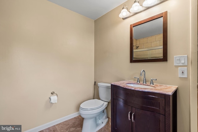 bathroom featuring vanity, toilet, and tile patterned flooring