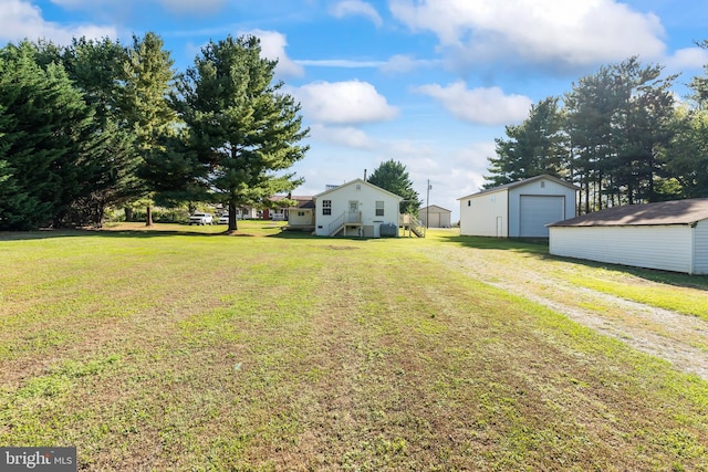 view of yard with an outdoor structure and a garage