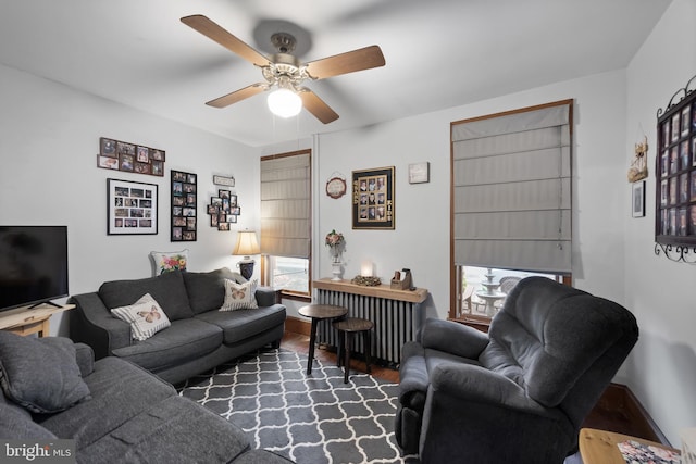 living room featuring ceiling fan, a wealth of natural light, and wood finished floors