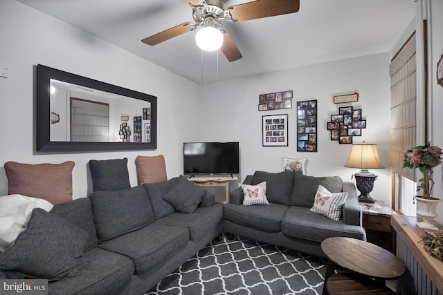 living room featuring radiator heating unit and a ceiling fan