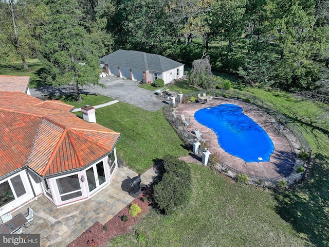 view of pool featuring a patio area and a lawn