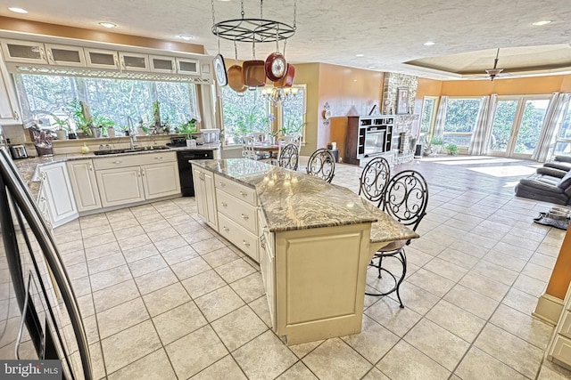 kitchen with a textured ceiling, plenty of natural light, and a kitchen island