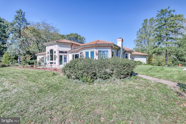 mediterranean / spanish-style house with a front lawn