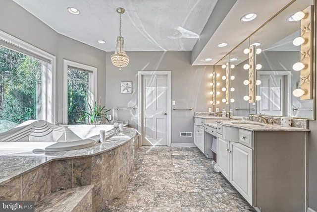 bathroom featuring vanity and a relaxing tiled tub