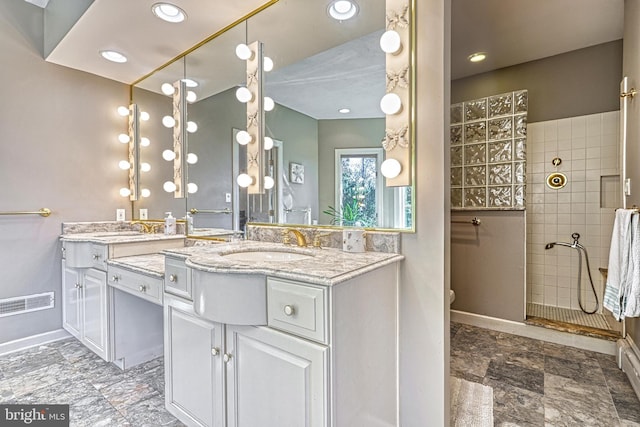 bathroom featuring vanity, toilet, and tiled shower