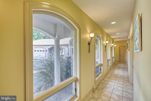 hall with light tile patterned floors