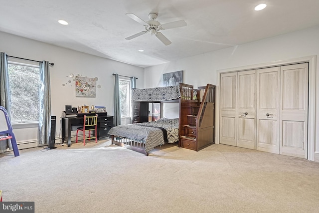 carpeted bedroom featuring multiple windows, a closet, and ceiling fan