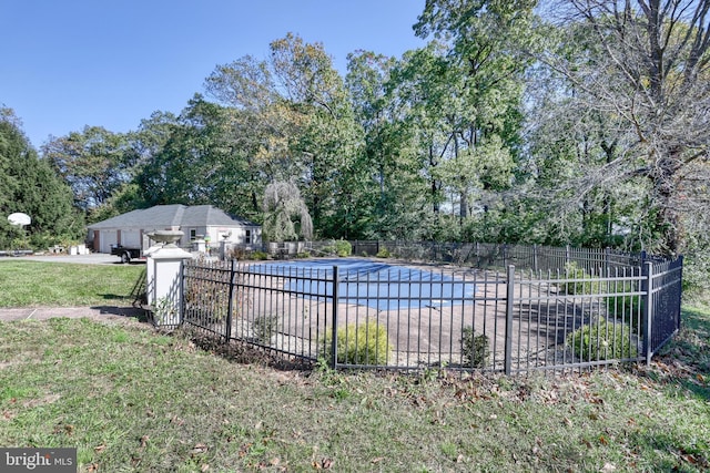 view of pool with a yard