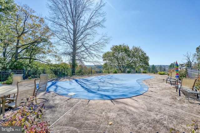 view of pool featuring a patio area and a mountain view