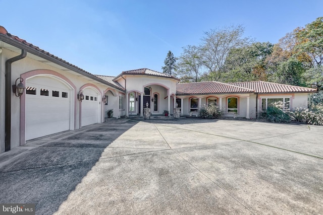 mediterranean / spanish-style home featuring a garage