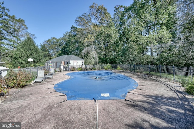 view of swimming pool with a patio