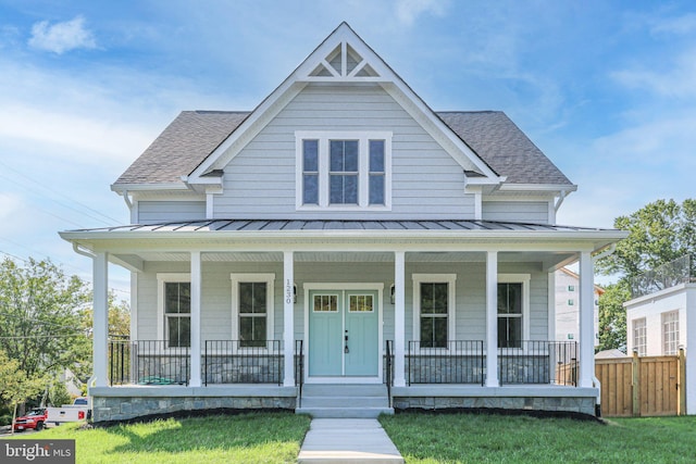 view of front facade with a front yard and a porch