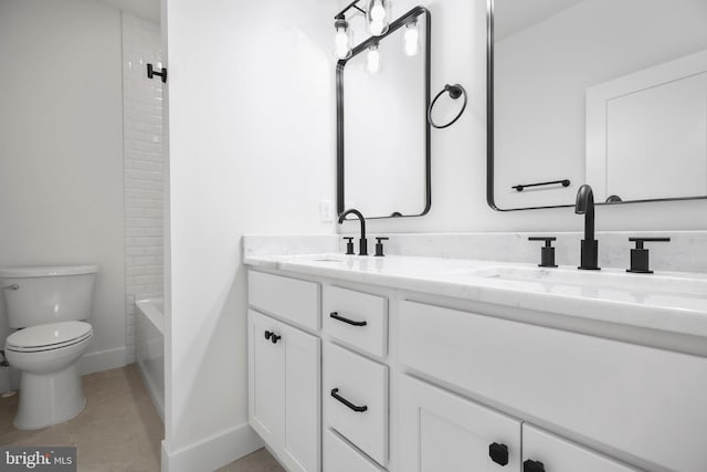 full bathroom featuring tiled shower / bath, vanity, toilet, and tile patterned flooring