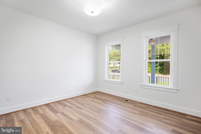 empty room with light hardwood / wood-style flooring