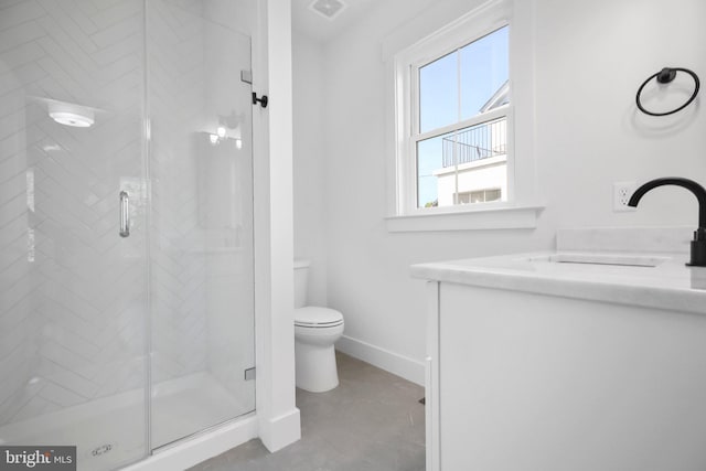 bathroom featuring toilet, a shower with shower door, and vanity