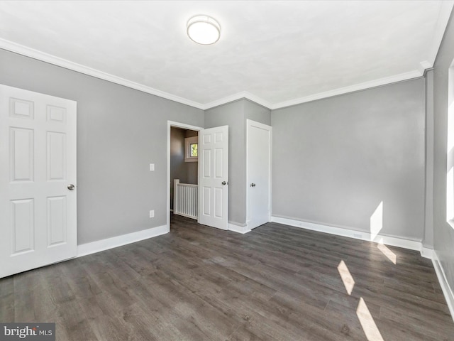 unfurnished bedroom with crown molding and dark hardwood / wood-style floors