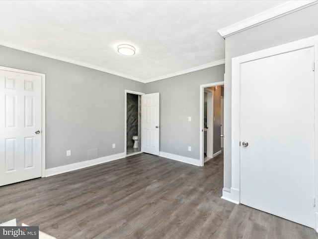 unfurnished bedroom with ornamental molding and dark wood-type flooring