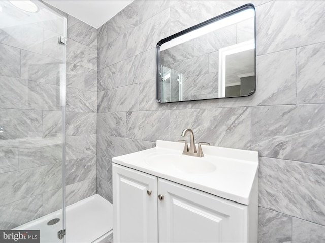 bathroom with vanity and tile walls